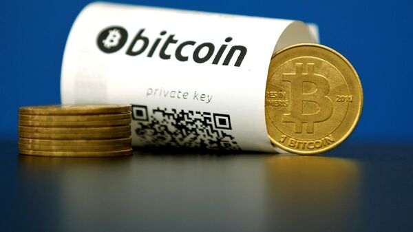 A Bitcoin (virtual currency) paper wallet with QR codes and a coin are seen in an illustration picture taken at La Maison du Bitcoin in Paris, France May 27, 2015 - اسپوتنیک ایران  