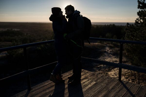 زوج جوان در میدانی در پارک ملی «نواره کورونی» در دریای بالتیک - اسپوتنیک ایران  