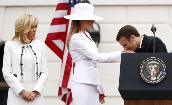 امانوئل مکرون رئیس جمهور فرانسه در حال بوسه زدن به دستان ملانیا ترامپ همسر رئیس جمهور آمریکا - اسپوتنیک ایران  