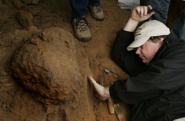 کارمند موزه هیوستون در حال مطالعه خاک زیر شهاب سنگ - اسپوتنیک ایران  