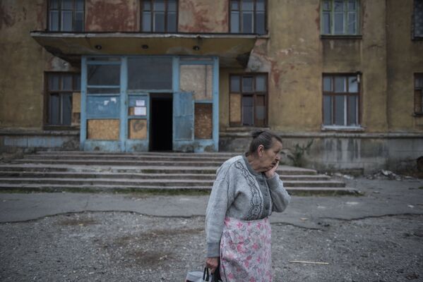 زنی در کنار خوابگاه شهر ماکییوک استان دونتسک - اسپوتنیک ایران  