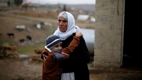 Ayman, a boy from a minority Yazidi community, who was sold by Islamic State militants to a Muslim couple in Mosul, hugs his grandmother after he was returned to his Yazidi family, in Duhok, Iraq, January 31, 2017 - اسپوتنیک ایران  