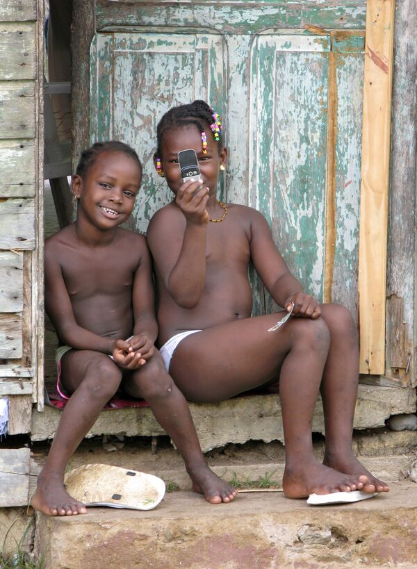 کودکان شهر سیناماری با تلفن همراه خود در گینه، سال ۲۰۰۷ - اسپوتنیک ایران  