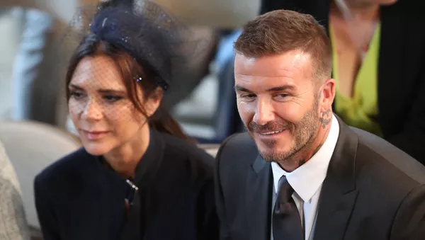 David and Victoria Beckham take their seats in St George's Chapel before the wedding ceremony of Britain's Prince Harry, Duke of Sussex and US actress Meghan Markle in St George's Chapel, Windsor Castle, in Windsor, on May 19, 2018.  - اسپوتنیک ایران  