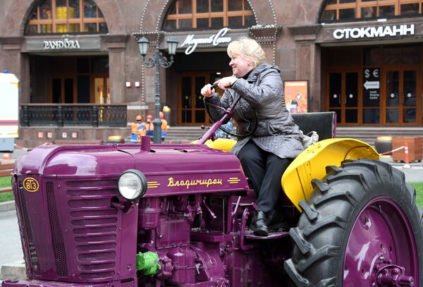 توریستی با ماشین کشاورزی در فستیوال مواد غذایی  پاییز طلایی در مسکو عکس می گیرد - اسپوتنیک ایران  