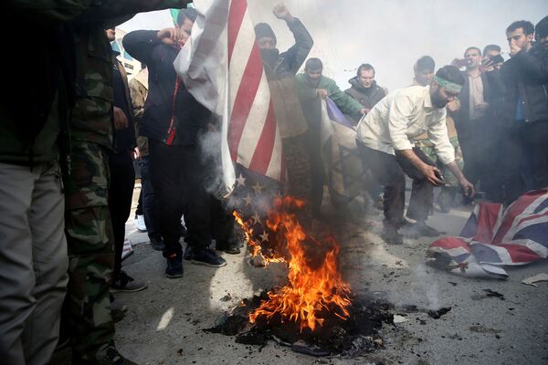 مردم ایران در حال آتش زدن پرچم آمریکا، اسرائیل و بریتانیا - اسپوتنیک ایران  