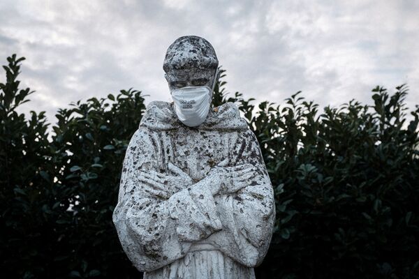 مجسمه قدیس فرانسیس، حامی ایتالیا در شهر سن فیورانو با ماسک بهداشتی  - اسپوتنیک ایران  