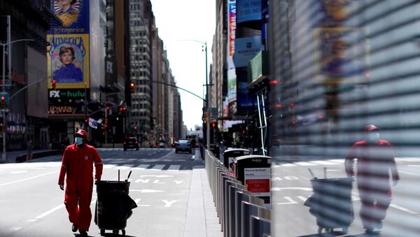 A Times Square Alliance street sweeper worker walks though a nearly empty Times Square in Manhattan during the outbreak of the coronavirus disease (COVID-19) in New York City, New York, U.S., April 7, 2020 - اسپوتنیک ایران  