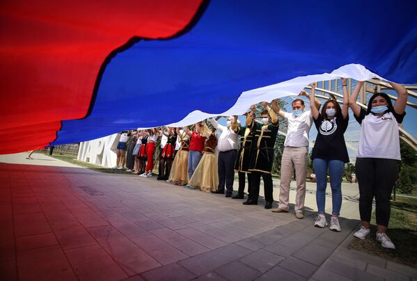 شرکت کنندگان در جشن روز روسیه، در پارک دوستی در شهر گئورگیفسک در استاوروپول،  پرچم کشور را در دست می گیرند.
 - اسپوتنیک ایران  