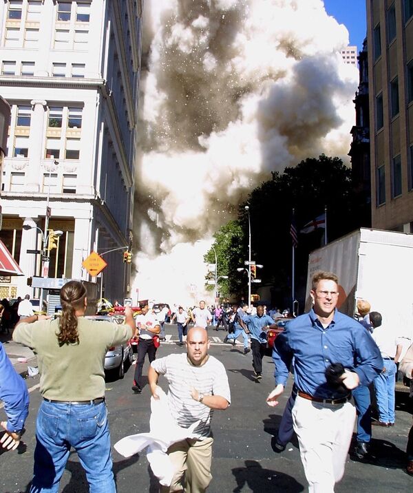 فرار عابران از برج های در حال سقوط مرکز تجارت جهانی در روز وقوع عملیات تروریستی 11 سپتامبر در نیویورک - اسپوتنیک ایران  