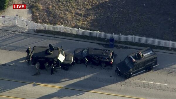 Police armored cars close in on a suspect vehicle following a shooting incident in San Bernardino. - اسپوتنیک ایران  